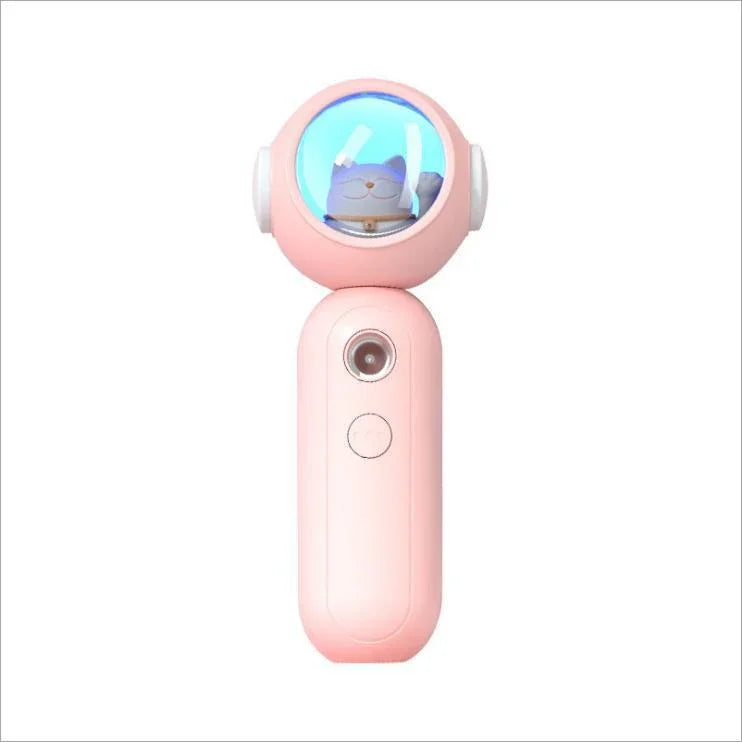 Pink handheld gadget with round top featuring a cat figure inside a blue-lit dome