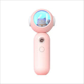 Pink handheld gadget with round top featuring a cat figure inside a blue-lit dome