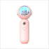 Pink handheld gadget with round top featuring a cat figure inside a blue-lit dome