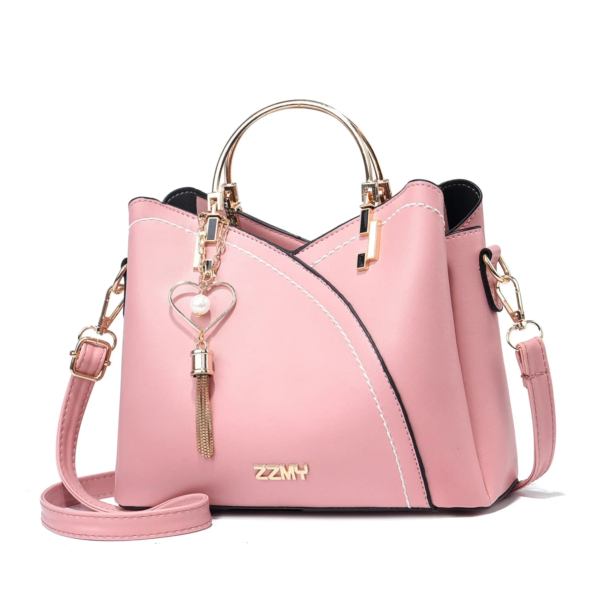 Pink faux leather handbag with gold metal handle, crossbody strap, and heart tassel charm
