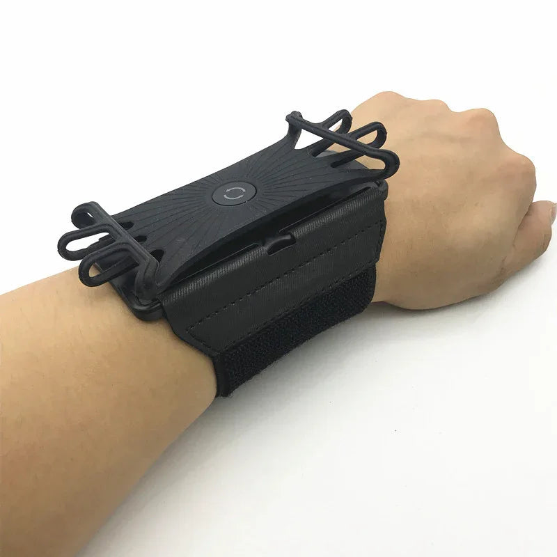 Black adjustable wrist strap phone holder with elastic bands and secure fit, worn on wrist