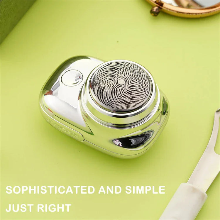 Compact silver electric shaver with circular foil head on light green background