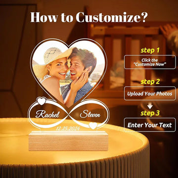 Custom heart-shaped acrylic photo lamp with names and date, warm ambient setting.