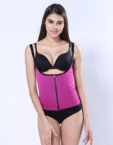 Woman wearing a fitted pink zip-up waist trainer vest over black underwear