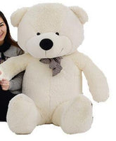 Large plush white teddy bear with a checkered bow tie, soft fur, and oversized fit.