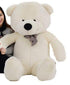 Large plush white teddy bear with a checkered bow tie, soft fur, and oversized fit.