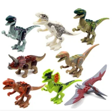 Set of colorful plastic dinosaur toy figures in various poses on a white background