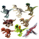 Set of colorful plastic dinosaur toy figures in various poses on a white background