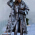 Oversized gray coat with abstract face print, relaxed fit, worn over ripped jeans