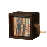 Dark wood hand-crank film viewer displaying retro scene with people indoors