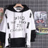 Oversized black and white graphic hoodie with bold front text and relaxed streetwear fit