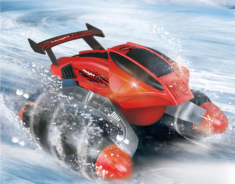 Red futuristic remote control car with large wheels driving on snow or ice