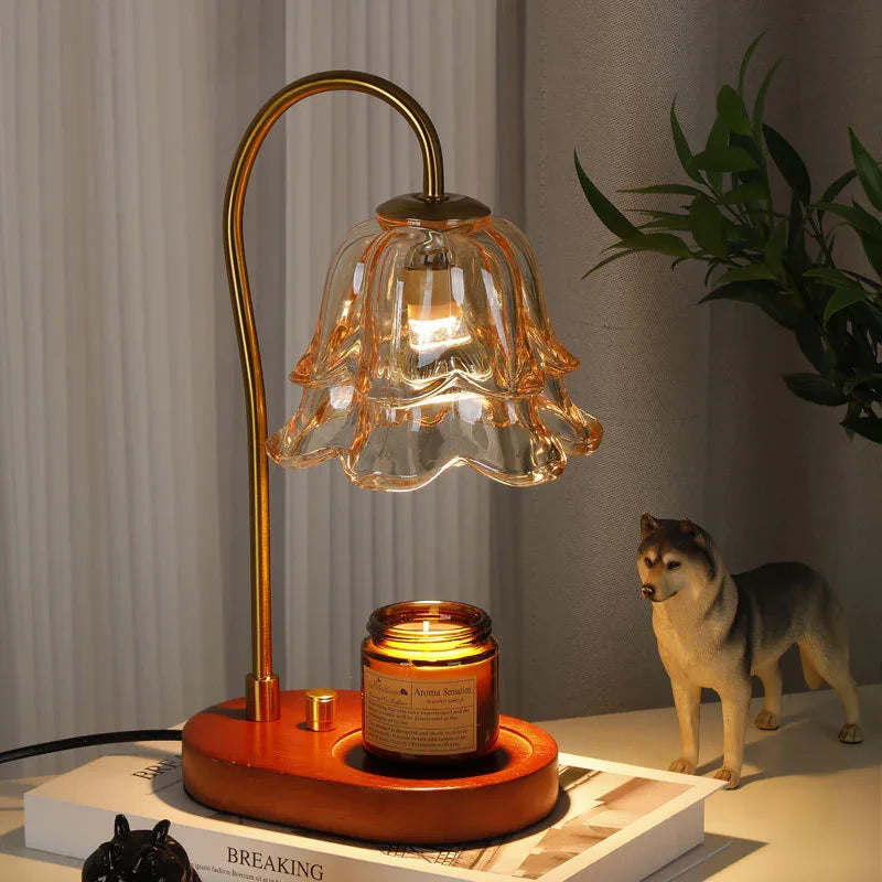 Vintage-style glass flower lamp with gold stem and wood base, warm light on desk