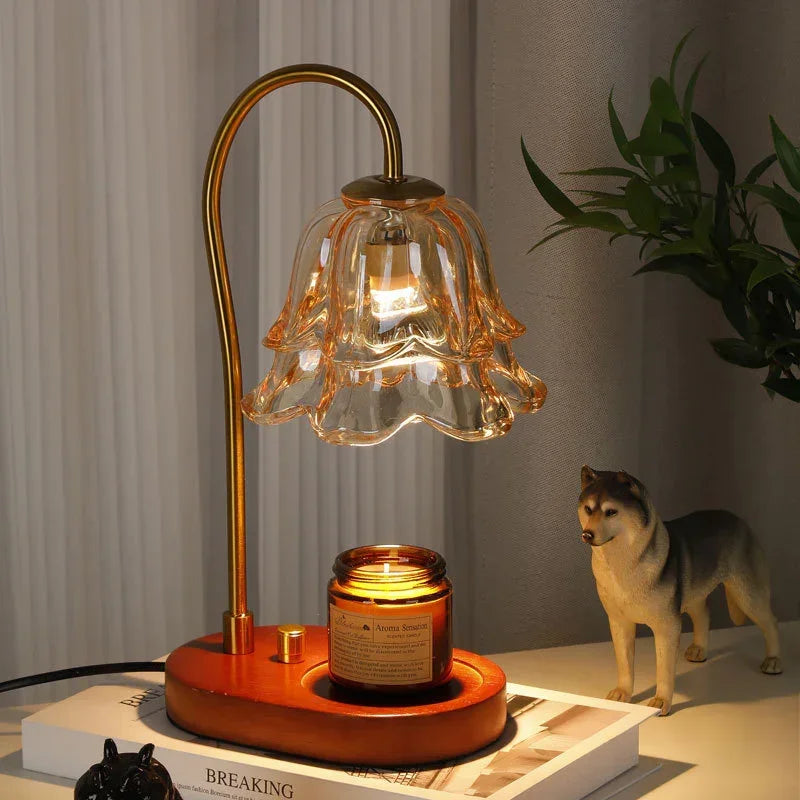 Vintage-style glass flower lamp with gold stem and wood base, warm light on desk