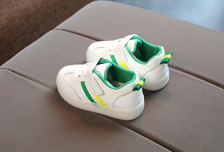 White low-top sneakers with green and yellow stripes, sporty design, kid's casual shoes