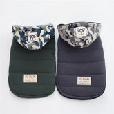 Two padded pet jackets, one dark green and one navy, with camo hoods and cartoon patches.
