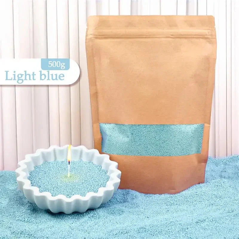 Light blue wax beads in a resealable pouch and a scalloped bowl, for candle making.
