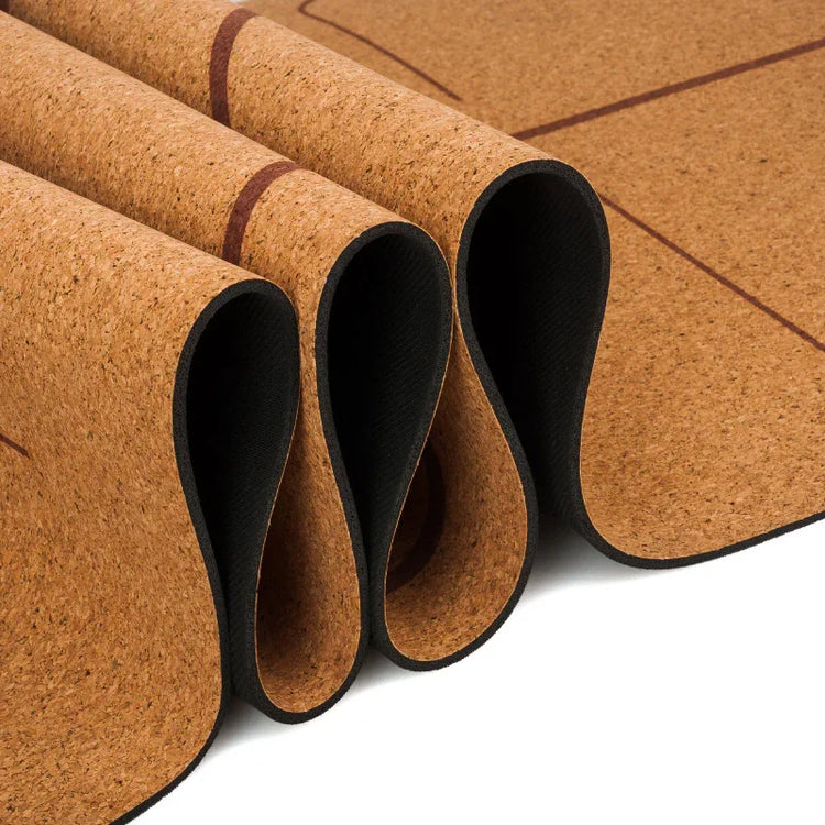 Rolled natural cork yoga mat with black non-slip backing and subtle line pattern