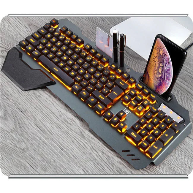 Mechanical keyboard with orange LED backlighting, black keys, wrist rest, and phone holder on a desk