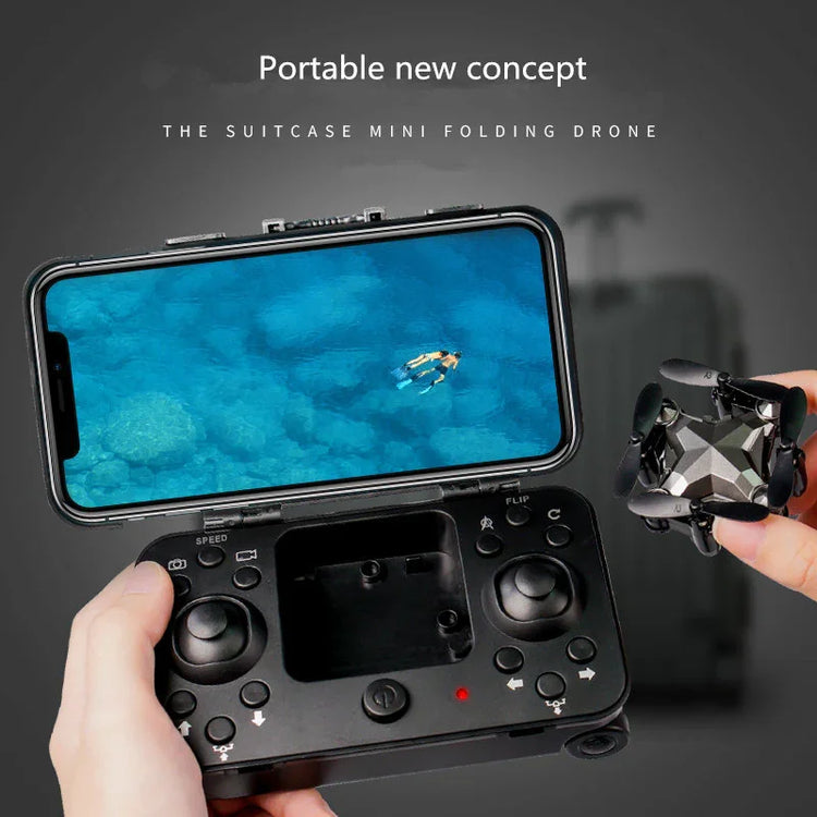 Hand holding a black mini folding drone and remote control with smartphone screen, modern tech accessory