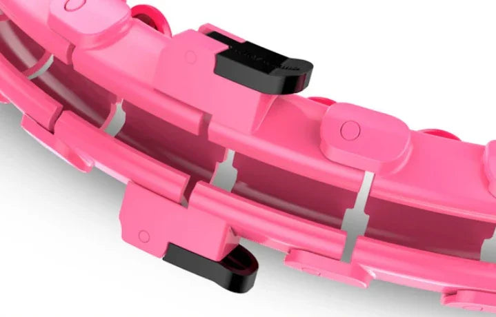 Close-up of pink adjustable plastic links with black clips, athletic accessory detail