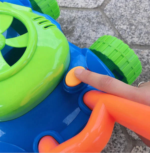 Hand pressing button on colorful plastic toy lawn mower with green wheels and handle
