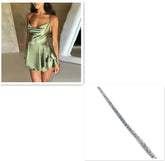 Woman wearing a satin green mini dress with a draped neckline, fitted waist, and flowy skirt