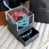 Gift box with blue and pink preserved rose and blue beaded bracelet in drawer, on knit fabric