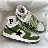 Green and white low-top sneakers with black star detail, paired with white crew socks