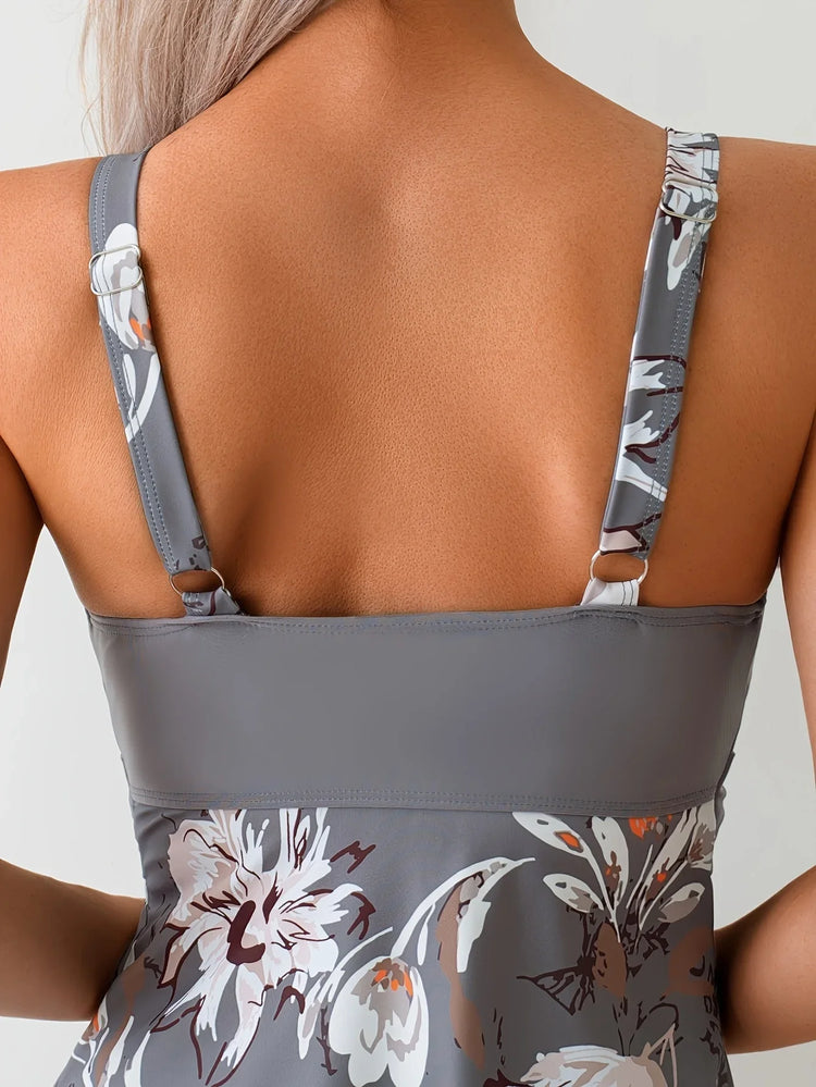 Back view of woman wearing grey floral print tank top with adjustable straps, smooth fit