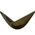 Person lying in an olive green, lightweight, fabric hammock with relaxed casual fit clothing