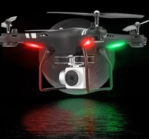 Black quadcopter drone with camera, LED lights, and futuristic design flying at night.