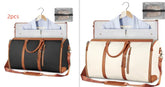 Two travel duffel bags, one black and one white with brown leather straps, each holding a folded shirt and suit, ideal for organized, stylish travel.