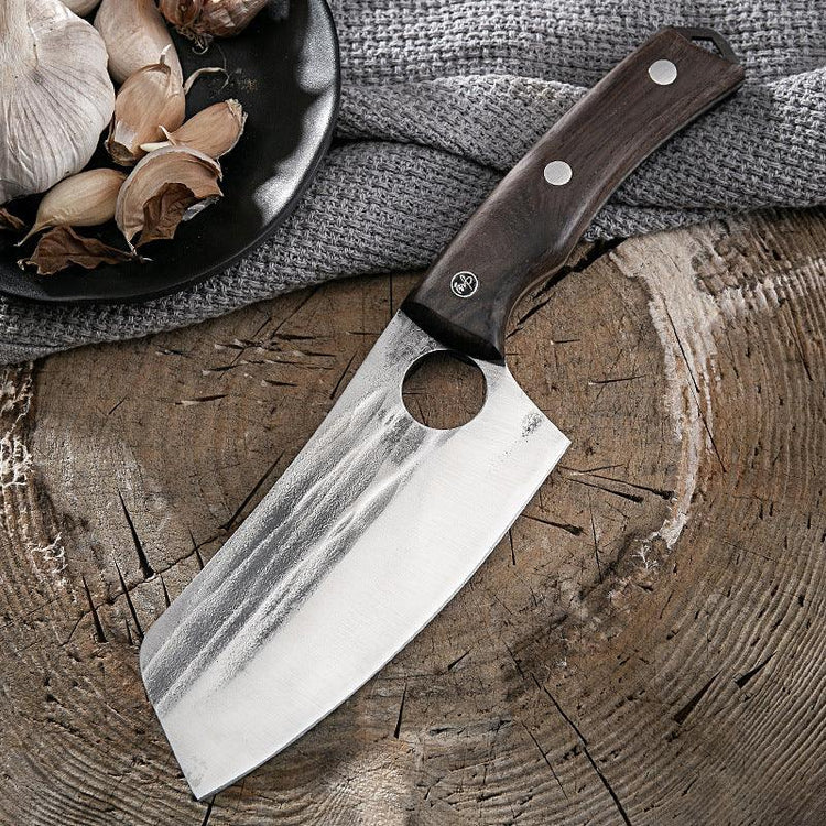 Stainless steel cleaver knife with dark wood handle and textured blade on rustic wood surface