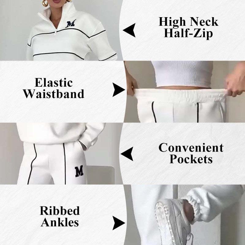 White streetwear tracksuit with black piping, high neck half-zip, elastic waistband, ribbed ankles, and pockets.