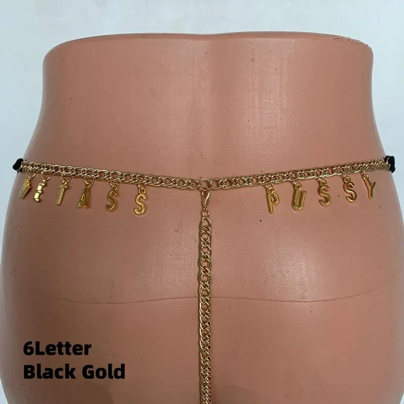 Gold-tone chain body jewelry with dangling letter charms and a cheeky design, fitted on a mannequin