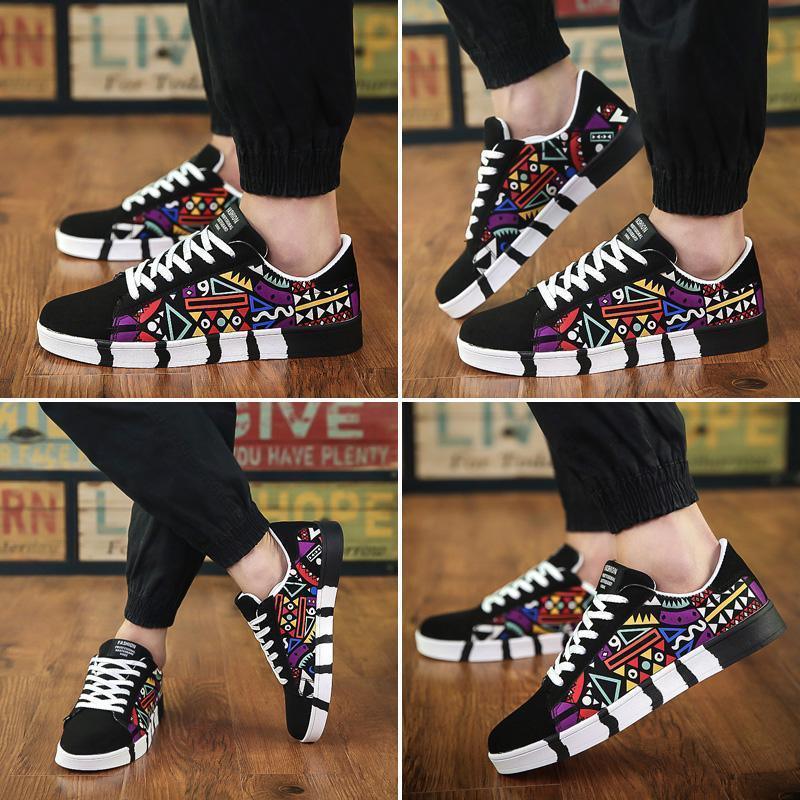Men's low-top sneakers with black suede, colorful geometric patterns, and white soles
