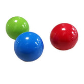 Glossy green, blue, and red plastic balls on white background