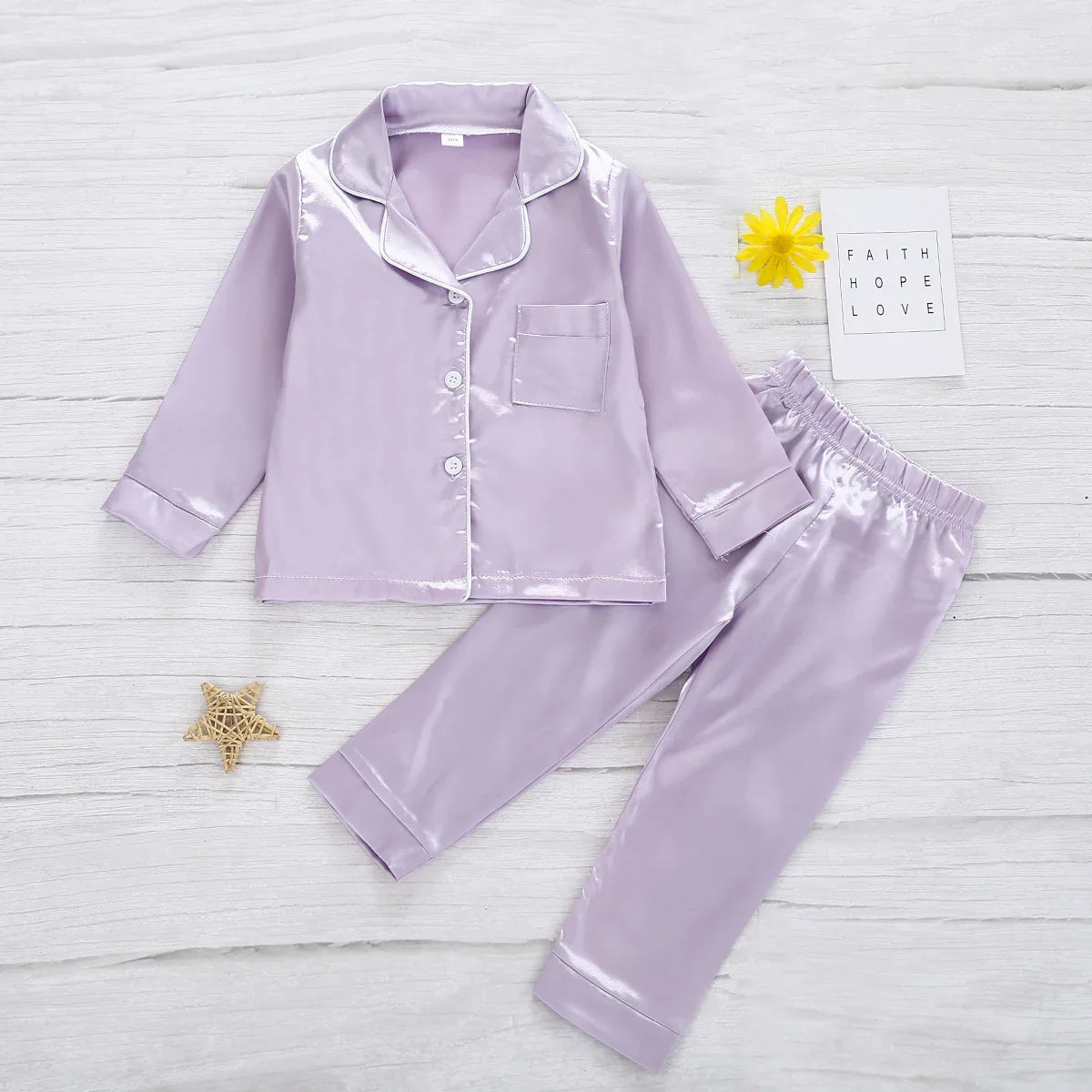 Lavender satin pajama set with button-up top, pocket, and elastic waist pants, relaxed fit