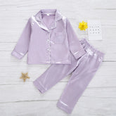 Lavender satin pajama set with button-up top, pocket, and elastic waist pants, relaxed fit