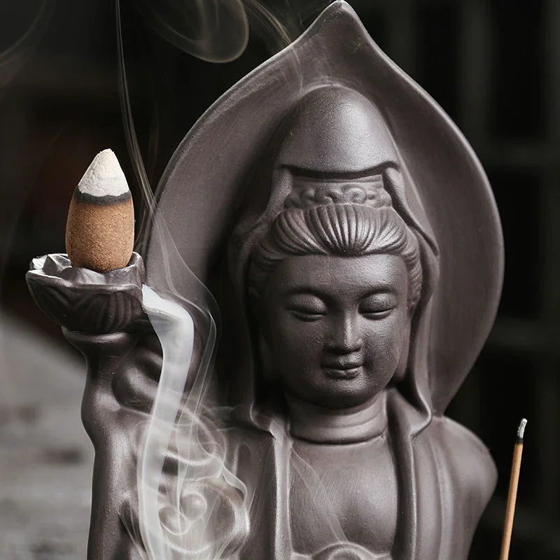 Ceramic deity statue incense holder with flowing smoke, dark brown matte finish