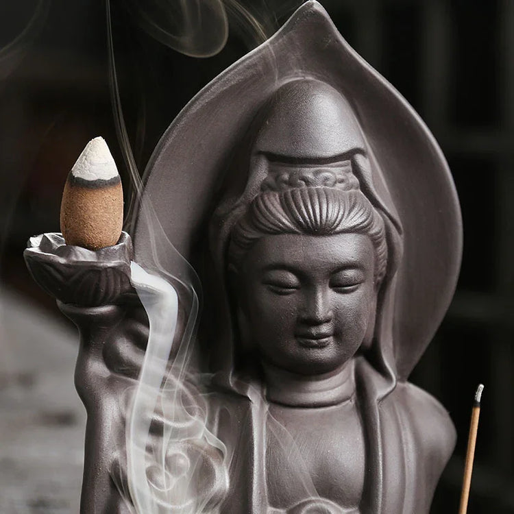 Ceramic deity statue incense holder with flowing smoke, dark brown matte finish