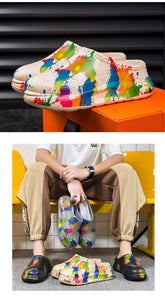 Colorful paint splatter slip-on clogs in cream, black, and gray with comfortable casual fit.
