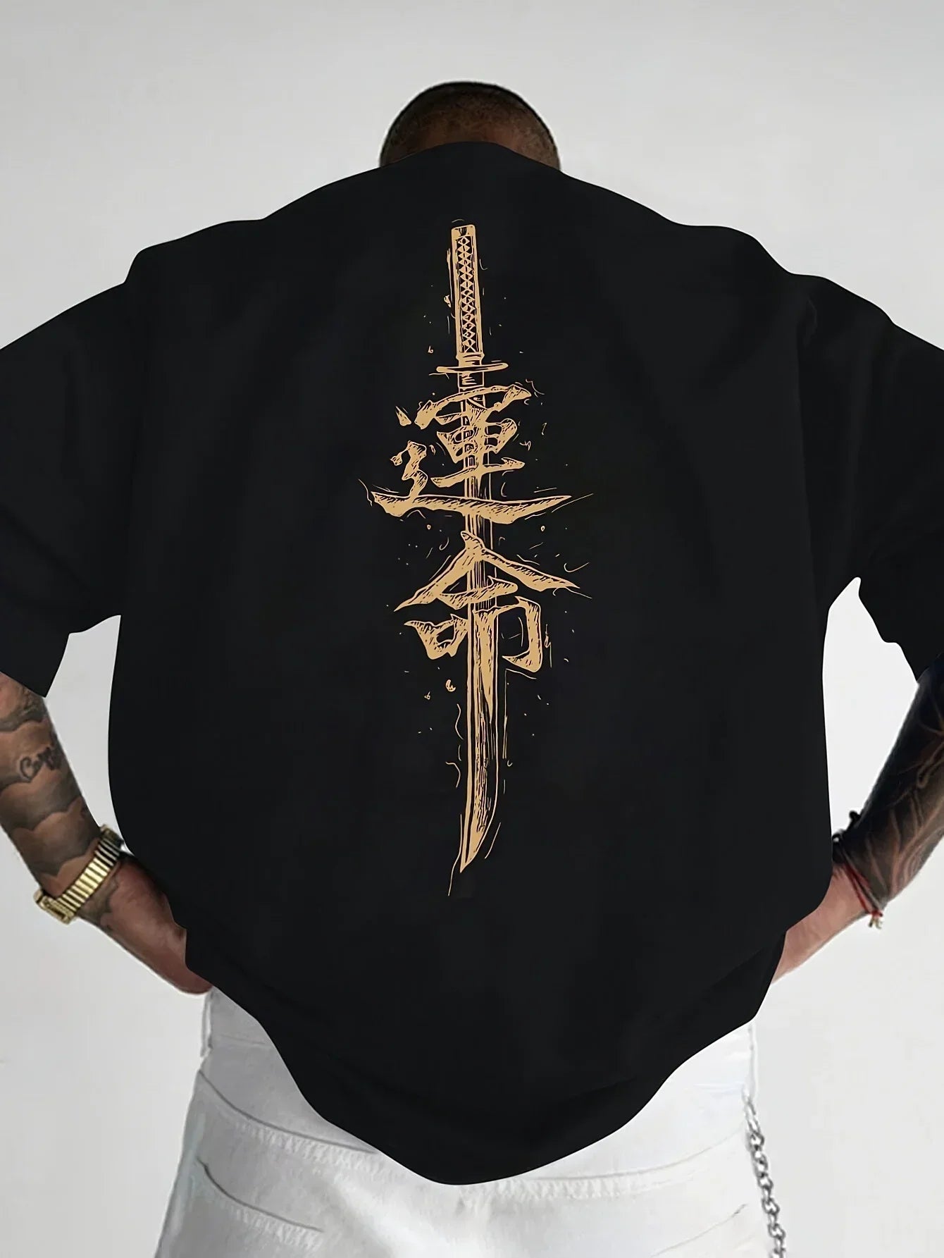 Oversized black streetwear t-shirt with gold katana and Japanese graphic on back