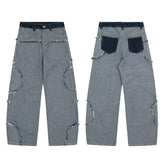 Wide-leg gray denim jeans with raw edge details, patchwork pockets, and relaxed fit.