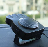 Black portable car heater and defroster with vented design on dashboard
