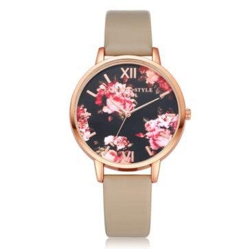 Beige leather strap watch with rose gold case and floral pattern on black dial
