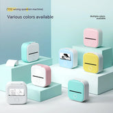 Mini portable thermal printers in pastel blue, pink, yellow, and white, compact square design