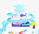 Colorful plastic fishing game set with blue tracks, fish figures, and ocean-themed background