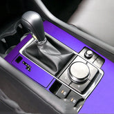 Purple metallic car gear shift panel with black leather gear lever and control dials